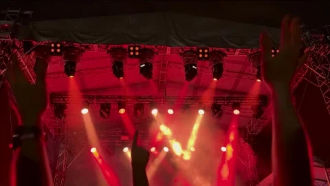 Hands clapping in front of live concert stage lights Stock Footage 334941529