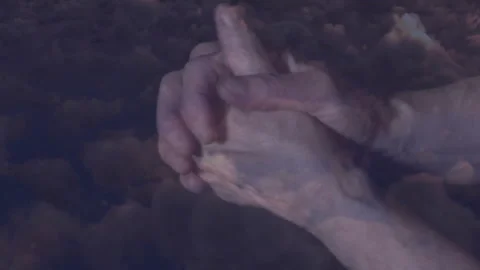 Hands clasped together against dark clouds, creating dramatic animation effect 스톡 동영상 305836110