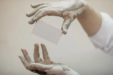Hands in clay after work at the potter's wheel, close-up holding a mockup of a Stock Photos
