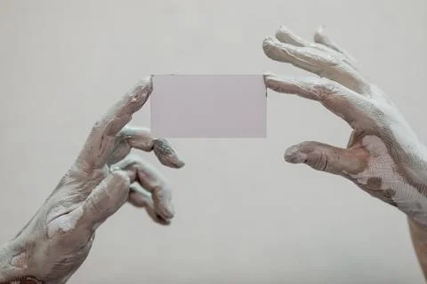 Hands in clay after work at the potter's wheel, close-up holding a mockup of  Foto stock