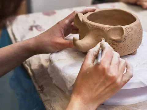 Hands in clay make a ceramic bowl Stock Photos