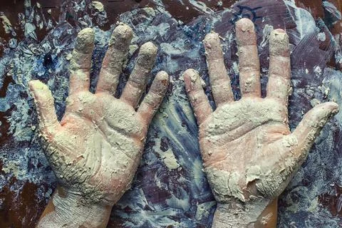 Hands in clay Stock Photos