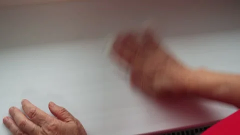 Hands clean window frame during home task in sunny room in afternoon with no vis Stock Footage 330889901