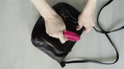 Hands cleaning and scrubbing a black leather bag with a brush at home, conc.. Stock Footage 315517780