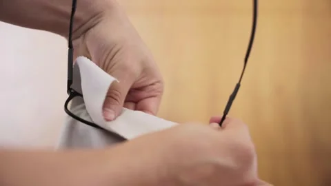 Hands Cleaning Black Frame Glasses using a Gray Microfiber Cloth Stock Footage 262642022