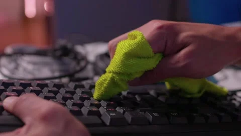 Hands cleaning computer keyboard with brush and microfiber cloth in close-up Stock Footage 347870257