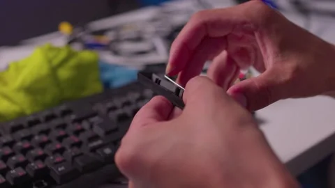 Hands cleaning computer keyboard with brush and microfiber cloth in close-up Stock Footage 347870263