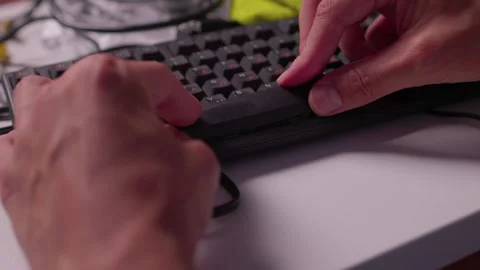 Hands cleaning computer keyboard with brush and microfiber cloth in close-up Stock Footage 347870272