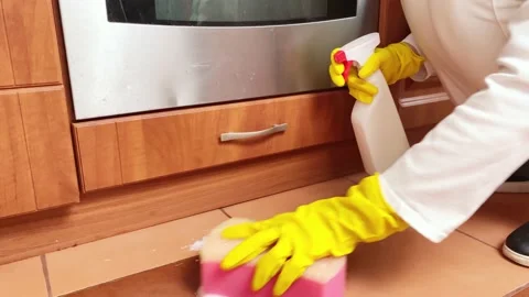 Hands clearing floor in kitchen. Stock Footage 171018797