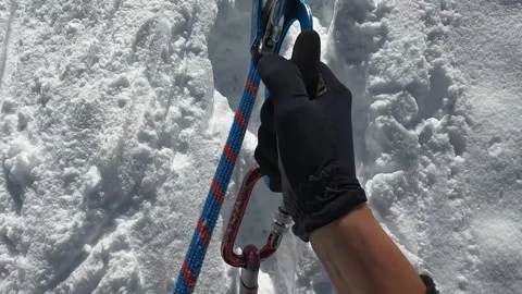 Hands of a climber, holding onto a jumar and climbing up the mountain Stock Footage 246292775
