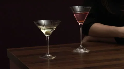 Hands clinking glasses of Martini and Cosmopolitan Stock Footage 24653801