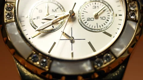 Hands of the clock in motion and dial clock face of a gilded gold plated watch Video stock 221273895