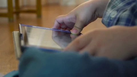 Hands of a close-up of a child playing on a tablet Stock-Footage 75691190