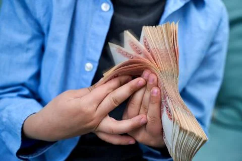 Hands close-up consider a large currency of Russian rubles Stock Photos