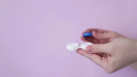 Hands close containers with contact eye lenses Stock Footage 236198847