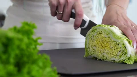 Hands close up cutting salad with a knife. Stock Footage 132268875