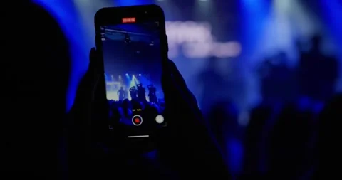 Hands close-up filming the performance of artists on stage on the phone Stock Footage 271208809