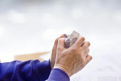 Hands close-up on light background with crumpled paper, space for copy Stock Photos