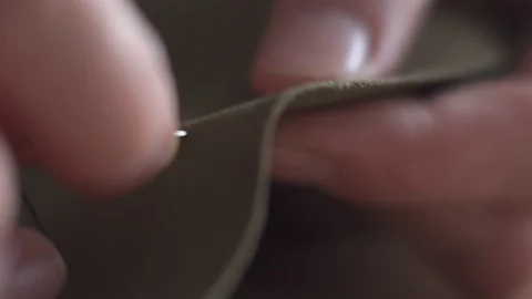 Hands close-up macro sewing clothes needle Stock Footage 100706091
