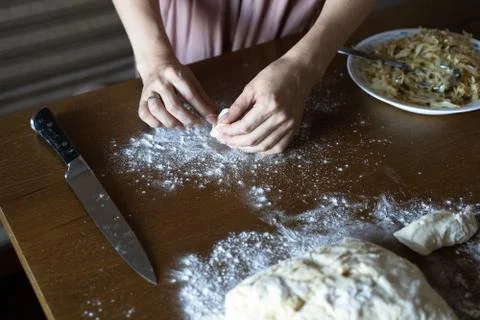 Hands close up mold out dough pie. dough and flour on the table Stock Photos