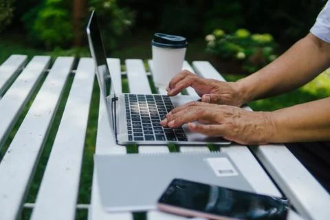 Hands close up of old man using laptop Stock Photos