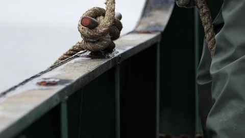 Hands in close-up tie rope in slow motion showcasing the art of knot security To Stock Footage 263495447