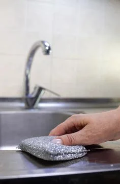 Hands close up washing with a sponge chrome faucet Stock Photos