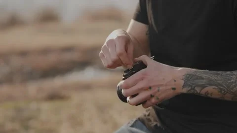 Hands close-up: a young attractive brutal male photographer with a tattoo Video stock 140920116
