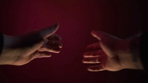 Hands closeup. Rubs his hands on a dark red background Stock-Footage 127116540