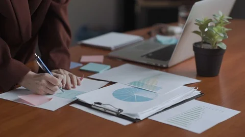 Hands closeup with statistical data. Financial reports, praphs. pie chart, bar Stock Footage 129267163