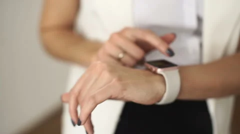 Hands closeup. Woman using her smartwatch touchscreen device in cafe Stock Footage 68982545