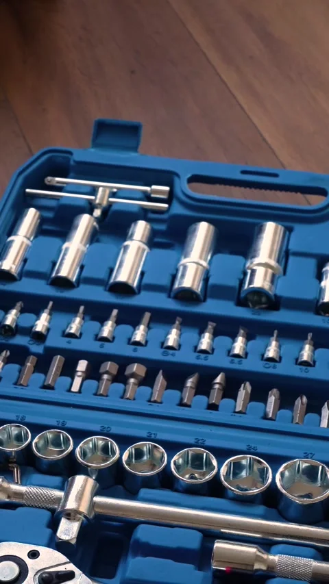 Hands closing a blue plastic toolbox with a professional socket wrench Stock Footage 346234827