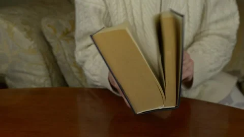 Hands closing a thick big book. Close up shot of hardcover shutting Stock Footage 328600519