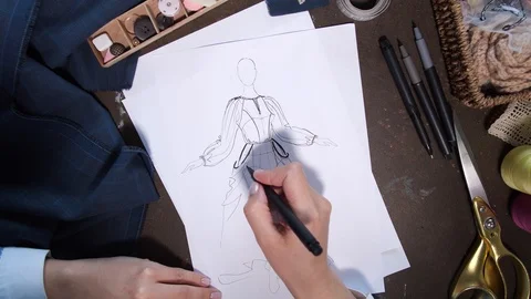 Hands of clothes designer drawing sketch of dress Video stock 108125976