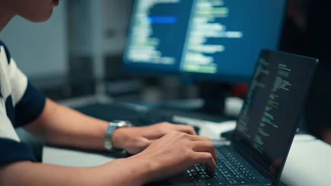 Hands coding secure software focused on backend programming, encryption, and Stock Footage 313808579