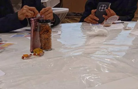 Hands collaborating in a creative herbal flower tea making workshop 写真素材