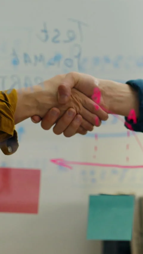 Hands of collaboration shake in an office during a brainstorming session wit Stock Footage 331597467