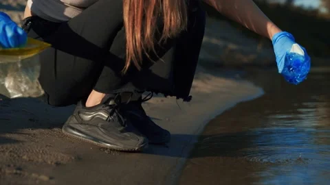 Hands collecting garbage from river, sea. Pollution concept. Stock Footage 218471538