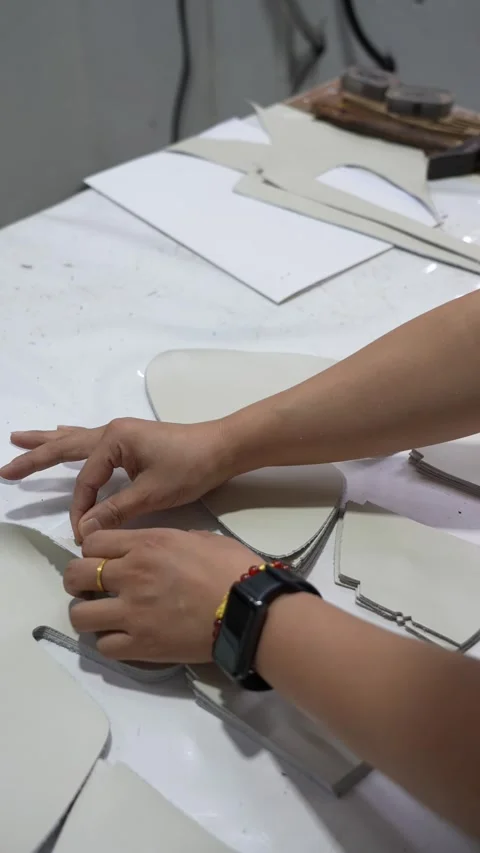 Hands Compare Footwear Pattern Components in Factory Vertical Stock Footage 340182780
