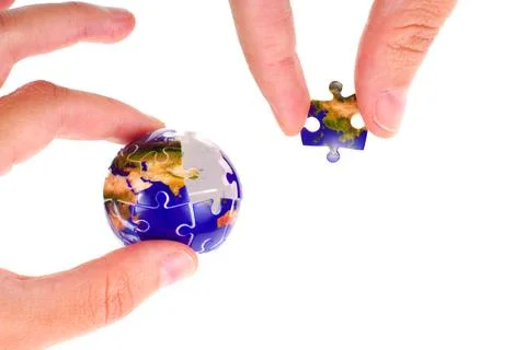 Hands Completing Earth Puzzle with Globe Background Stock Photos