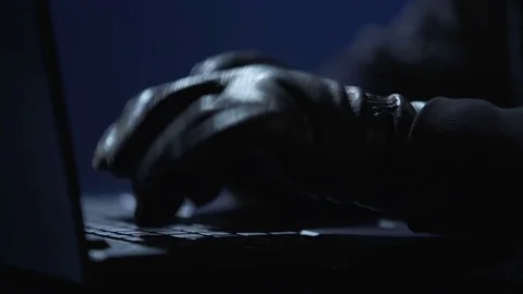 Hands of computer hacker in black gloves typing on laptop to hack banking system Stock Footage 71647668