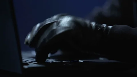 Hands of computer hacker in black gloves typing on laptop to hack banking system Stock Footage 71658472