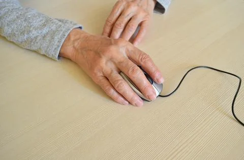 Hands on computer mouse Stock Photos