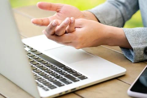 Hands of computer users have pain and injury to the fingers. From Syndrome Sy Stock Photos
