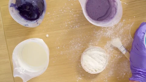 Hands of confectioner mixing components for mirror glaze Stock-Footage 98169417