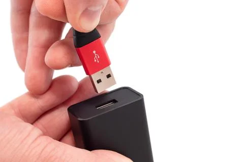 Hands connect the usb cable to the socket on a white background close-up. USB Stock Photos