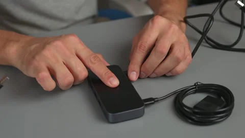 Hands connecting and testing wired computer mouse on desk with USB cable and Stockbeeldmateriaal 347533457