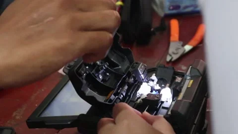 Hands connecting fiber optic cables for internet network Stock Footage 307371173