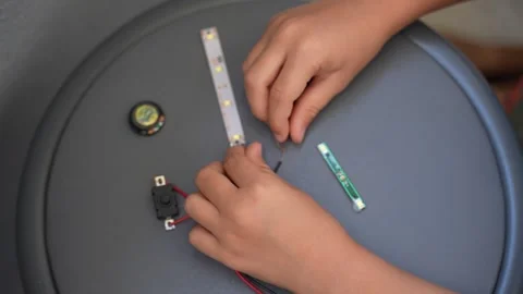 Hands Connecting LED Strip Lights and Electronic Components Stock Footage 346255017