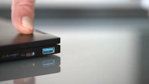 Hands connecting pendrive to blue usb port Video stock 146519488